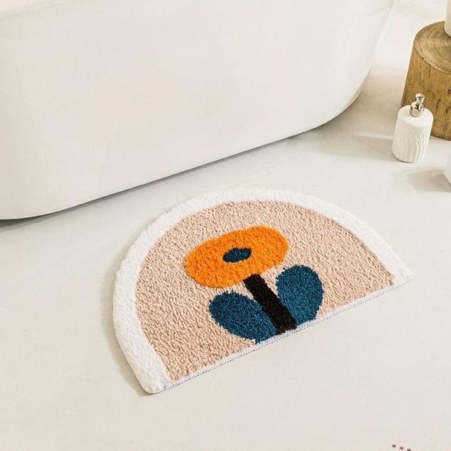 Halbrunde Badematte mit oranger Blume